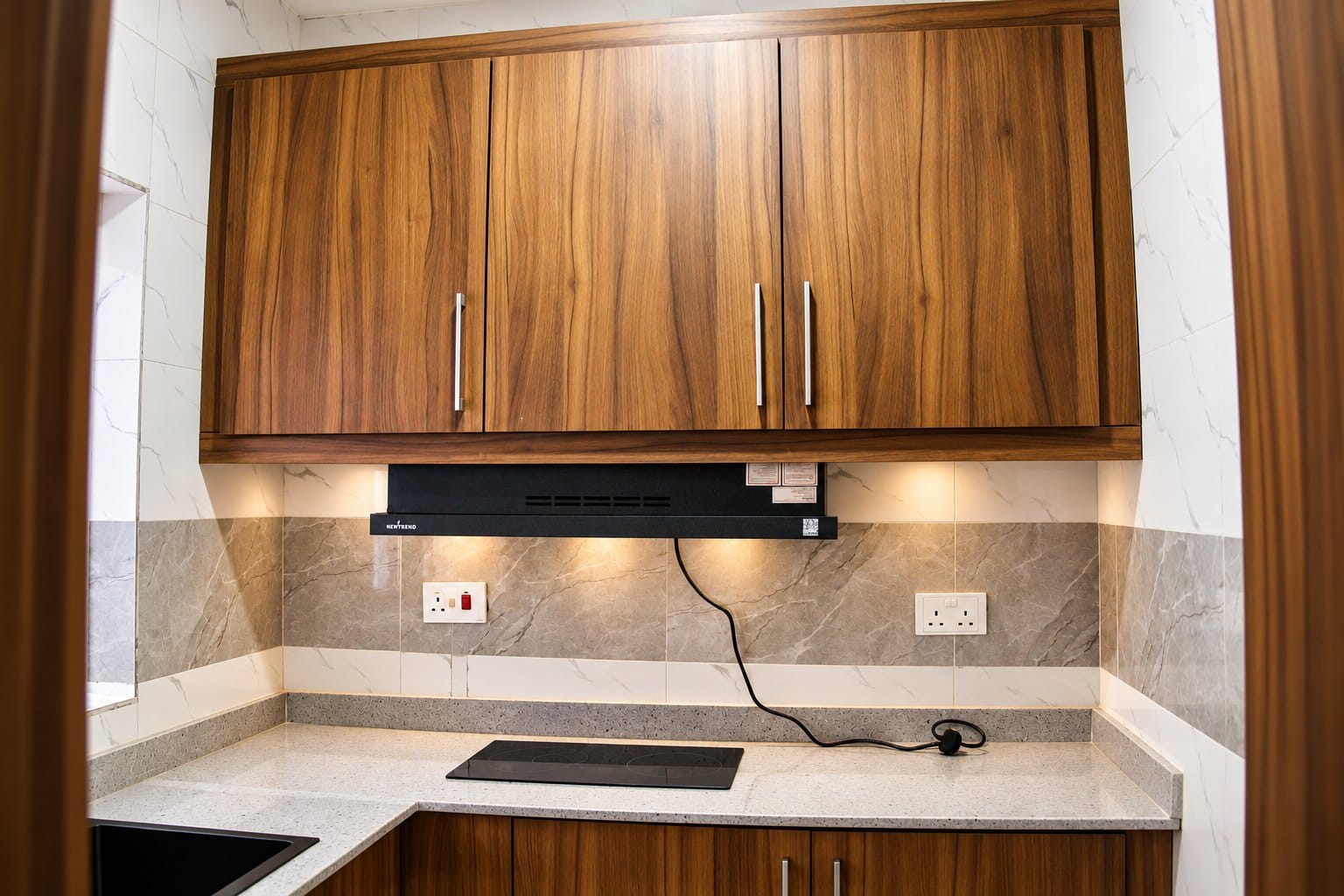 Penthouse Perfection: fitted kitchenette with stone splashback